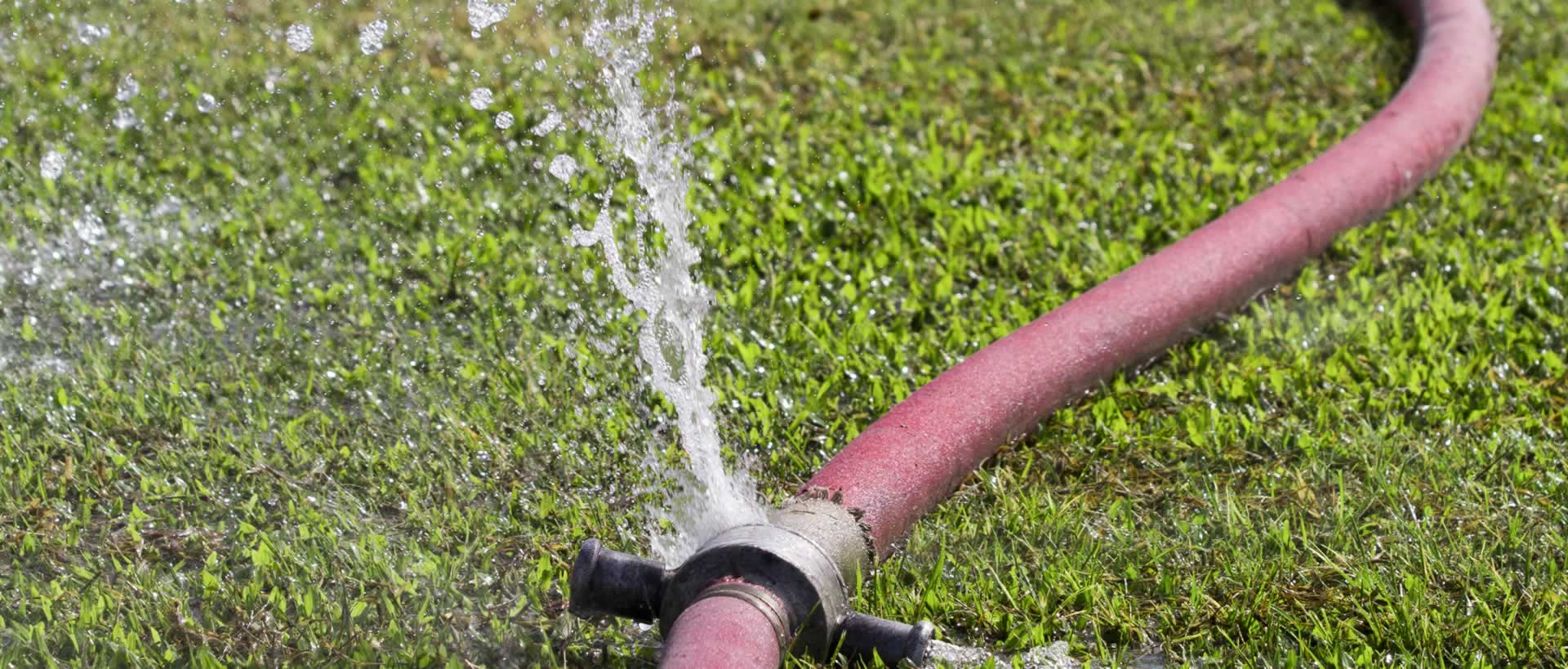 Background photo of a leaky garden hose